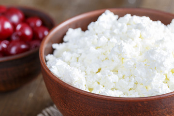 Cottage cheese on a wooden table close up