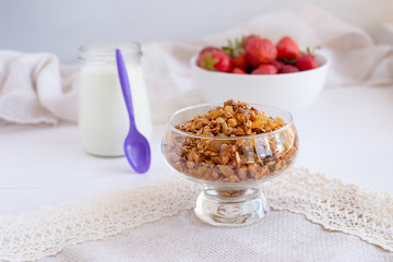 Homemade granola in jar on rustic kitchen table, healthy breakfa