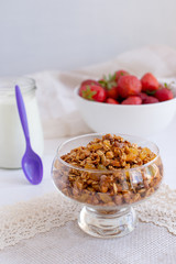 Homemade granola in jar on rustic kitchen table, healthy breakfa