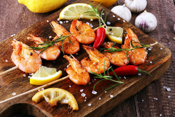 Grilled shrimp skewers. Seafood, shelfish. Shrimps Prawns skewers with herbs, garlic and lemon.