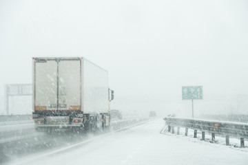 Snowfall on the highway, driving in bad weather with poor visibility.ity. - 194751805