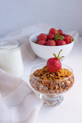 Homemade granola in jar on rustic kitchen table, healthy breakfa