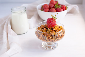 Homemade granola in jar on rustic kitchen table, healthy breakfa