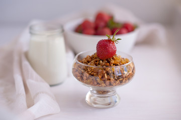 Homemade granola in jar on rustic kitchen table, healthy breakfa