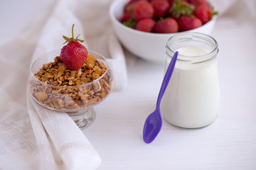 Homemade granola in jar on rustic kitchen table, healthy breakfa