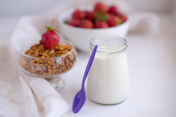Homemade granola in jar on rustic kitchen table, healthy breakfa