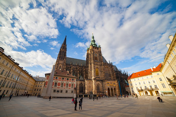 Fototapeta premium PRAGUE, CZECH REPUBLIC - APRIL 26, 2017: People walking by square around St. Vitus Cathedral in Prague, Czech Republic. Ultra wide view.
