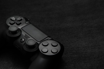 Black gamepad on a dark wooden background