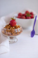 Homemade granola in jar on rustic kitchen table, healthy breakfa
