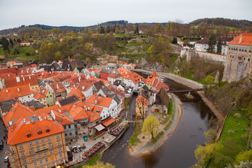 Fototapeta na wymiar Wide panoramic view of Cesky Krumlov from the highest castle tower. Cloudy spring weather. UNESCO World Heritage Site