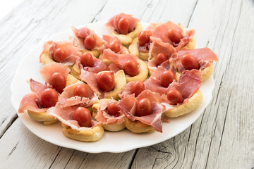Christmas appetizer with tomatoes and ham bread