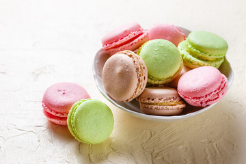 Colourful macaroons on the plates