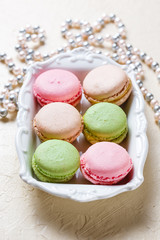 Colourful macaroons on the plates