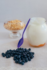 Homemade granola in jar on rustic kitchen table, healthy breakfa