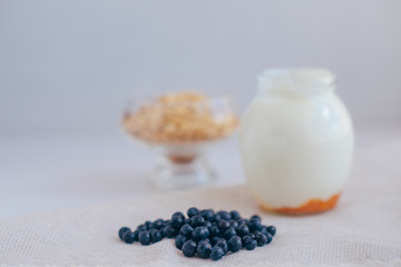 Fototapeta na wymiar Homemade granola in jar on rustic kitchen table, healthy breakfa