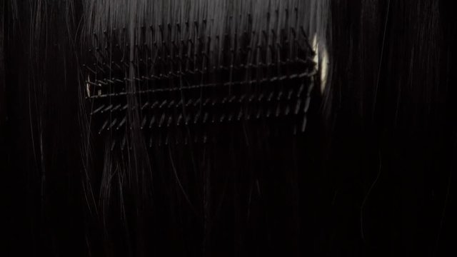 Hair texture background, no person. Black shiny hair comb texturte