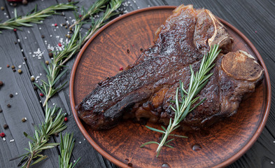 T-Bone Steak with Fresh Herbs on a rustic wooden table