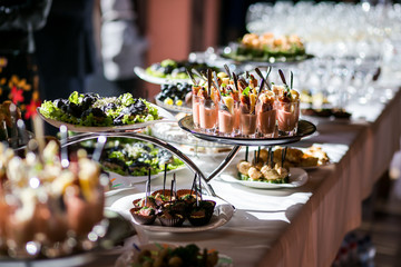 holiday buffet table served by different canape, sandwiches, snacks ready for eating in restaurant