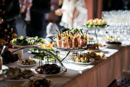 holiday buffet table served by different canape, sandwiches, snacks ready for eating in restaurant