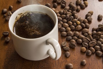 mug of fresh hot coffee and ground grains