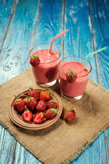 healthy strawberry yogurt with fresh berries on old wooden background
