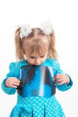 A child, a little girl, examines an X-ray.