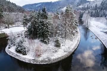 Beautiful snowy winter forest landscape, Tepla River under Brezova dam, Karlovy Vary, Czech Republic