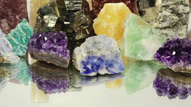 Semiprecious stones and minerals lies on the mirror, the riches of the Earth