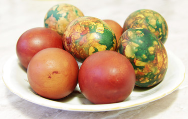Obraz na płótnie Canvas Colorful Easter Eggs On White Plate Placed By Heap