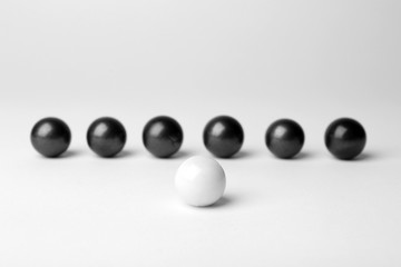 Decorative balls and one different on white background