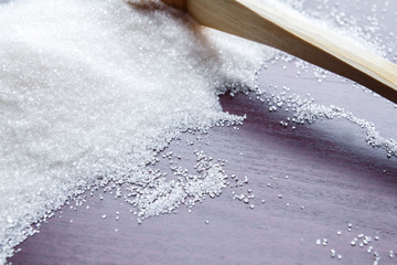 Sugar on wooden table. Selective focus