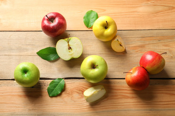 Ripe juicy apples on wooden table, top view