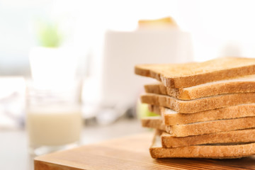 Tasty toasted bread on wooden board, closeup
