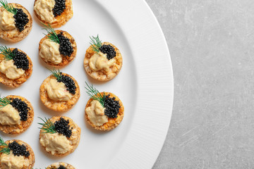 Tasty black caviar appetizer on plate