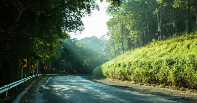 Time lapse of a countryside road within a forest during a sunny day, Chiang rai province, Thailand.