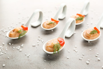 Delicious cod caviar in ceramic spoons on light background
