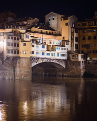 Fototapeta na wymiar Night view of medieval stone bridge Ponte Vecchio and the Arno River from the Ponte Santa Trinita (Holy Trinity Bridge) in Florence Tuscany, Italy. Florence is a popular tourist destination of Europe