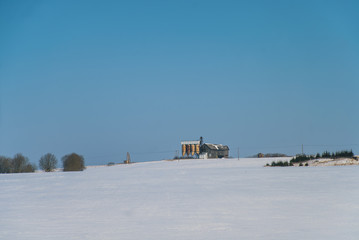Winter landscape with vintage grain dryer