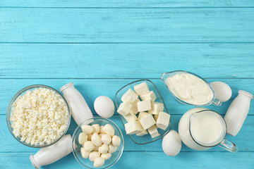 Fresh dairy products and eggs on wooden background