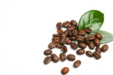 Shiny fresh roasted coffee beans with leaves isolated on white background