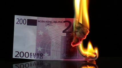 Euro bill in flames. European money burning on black background. Economic crisis or inflation concept. For this video it is used fake bank notes. - Powered by Adobe