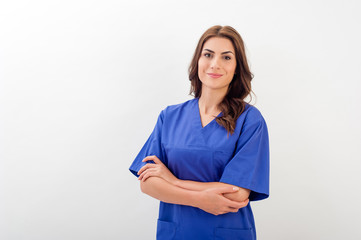 Smiling medical nurse in medical doctor uniform  isolated over white background. - obrazy, fototapety, plakaty