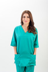 Medical nurse woman wearing blue surgery suit, standing on white background.