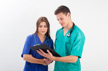 Medical professionals standing isolated. Young caucasian man and young woman nurse in medical scrubs.