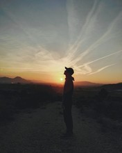 Young male in front of the sunset.