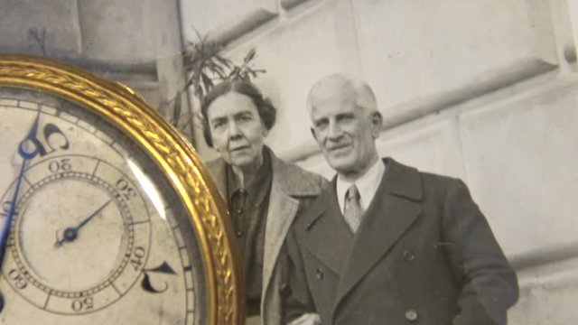 Old 1950's family photo with clock that marks the time.