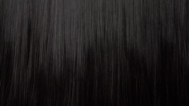 Hair texture background, no person. Black shiny hair with a comb