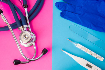 Protection glove, ENT (ear, nose, throat) spatula, two thermometers and medical stethoscope in two...