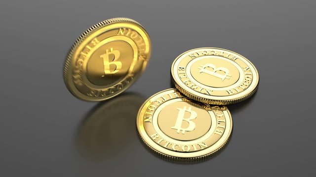 Two lying and one rotating golden bitcoins. 3D rendering. 4K UltraHD motion graphic animation.