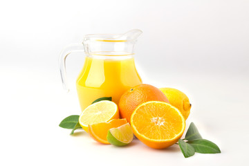 Fresh orange juice and citrus fruits lime lemon grapefruit in a jar white background healthy concept